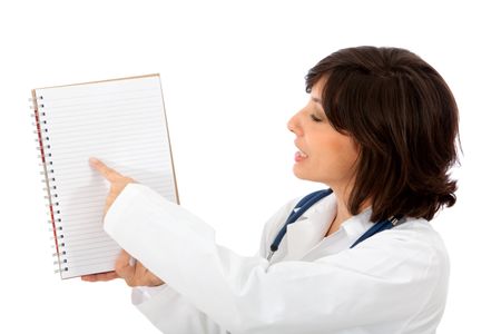 Female doctor pointing at her notes isolated over a white background
