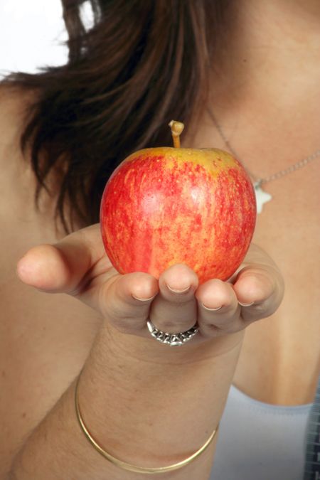 casual girl holding an apple on her hand