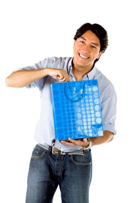 Handsome man opening a gift isolated on white