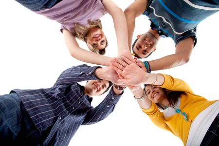Group of people wih their hands together in the middle - teamwork concepts
