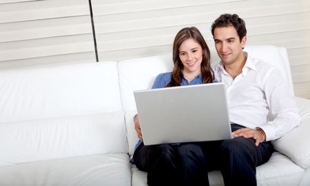 business couple sitting on the sofa with a laptop computer