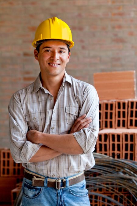 Male engineer smiling at a construction site