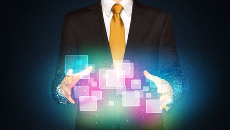 Businessman holding abstract glowing icons