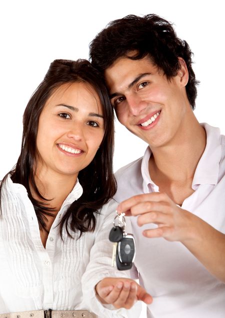 Beautiful couple with the car keys isolated on white