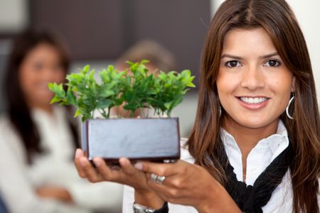 Beautiful business woman with a green plant