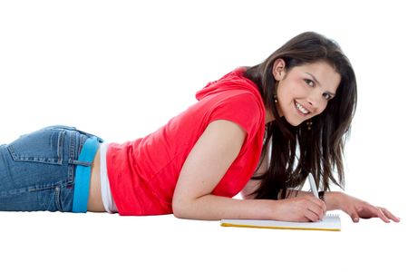 Beautiful student smiling and lying on the floor over a white background
