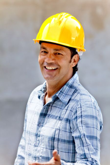Happy male construction worker wearing a helmet and smiling