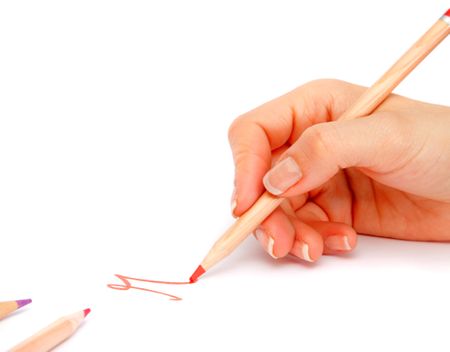 Hand holding a colour pencil and writing - isolated over a white background