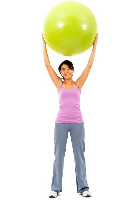 fitness woman smiling with a pilates ball isolated over a white background