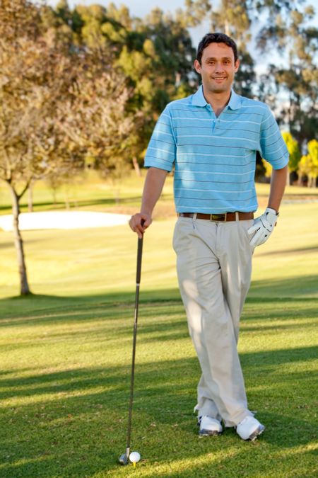 Young man playing golf leaning on the club