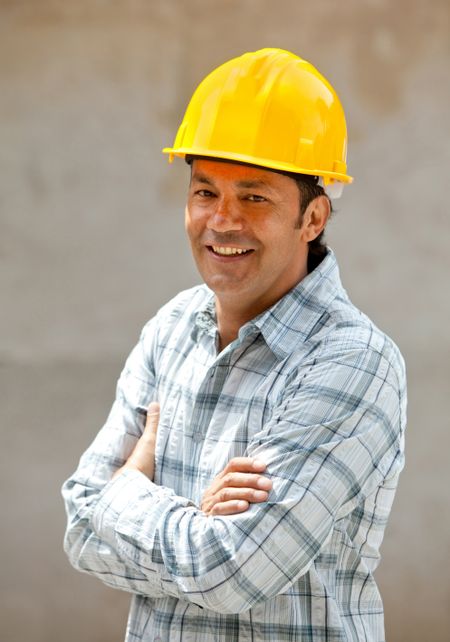 male architect at a construction site smiling