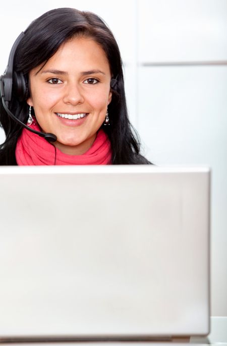 Customer services girl smiling on a laptop at the office
