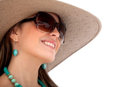 Beautiful summer woman smiling with hat and sunglasses over a white background