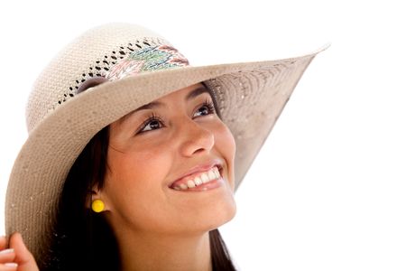 Beautiful summer woman smiling wearing a hat over a white background