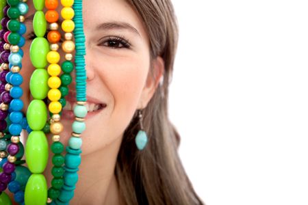 Woman with colorful necklaces in front of her face isolated over a white