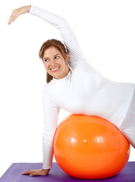 Woman exercising on a pilates ball isolated over a white background