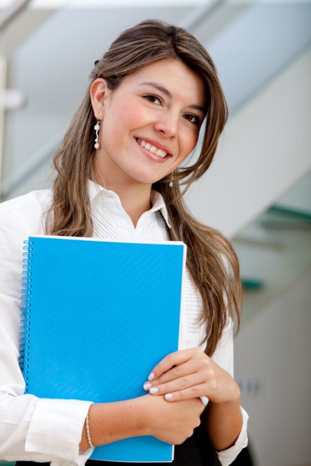 Business woman at the office holding a folder