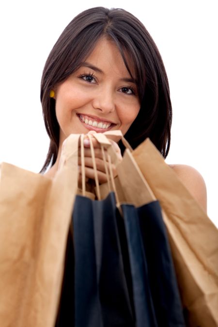 Shopping woman with bags smiling - isolated over a white background