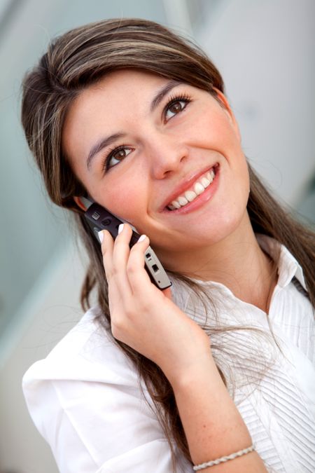 Business woman talking on the phone and smiling