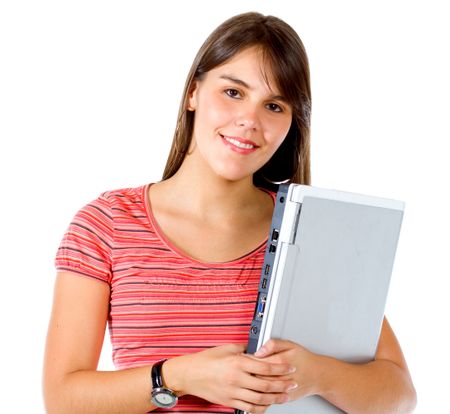 Casual girl smiling and holding a laptop computer isolated over a white background