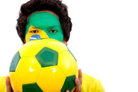 Portrait of a man with the brazilian flag painted on his face holding a soccer ball isolated over white
