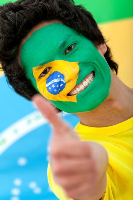 Portrait of a man with the Brazilian flag painted on his face - isolated