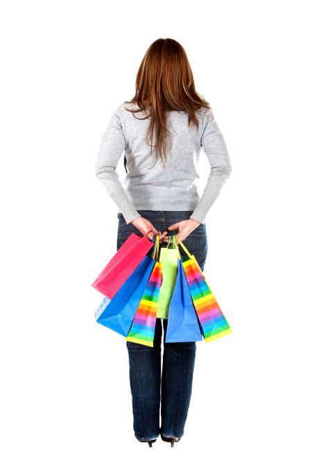Back of a woman holding shopping bags isolated over a white background