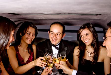 friends on a night out in a limousine with glasses of champagne