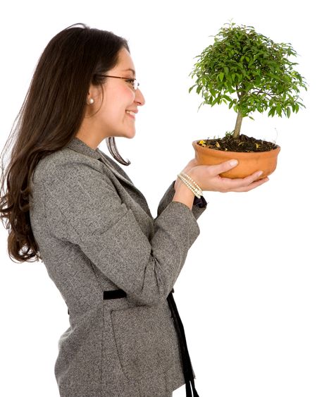 business woman holding a bonsai tree isolated over a white background