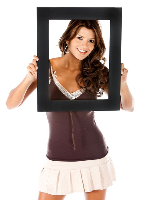 Beautiful woman holding a frame and smiling - isolated over white