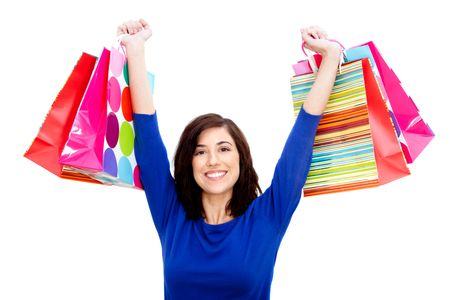 Happy shopping woman holding bags isolated over a white background