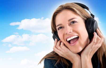 Woman with headphones with a blue sky on the background