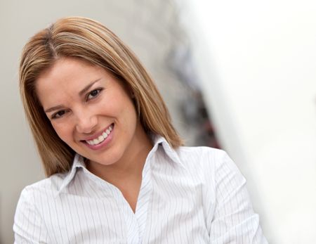 Beautiful business woman portrait smiling at the office