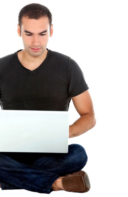 Man sitting on the floor with a laptop - isolated over a white background