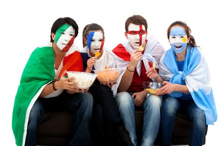 Patriotic group of people from different countries and flags painted on their faces watching television