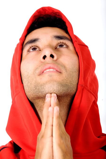 casual guy praying isolated over a white background
