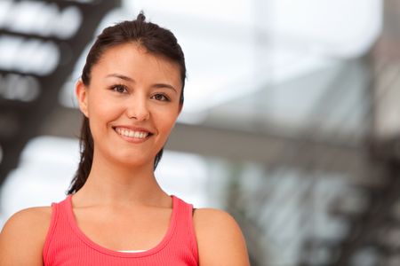 beautiful athletic woman portrait smiling at the gym