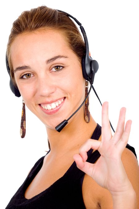 customer service girl smiling and wearing a headset - ok sign isolated over a white background