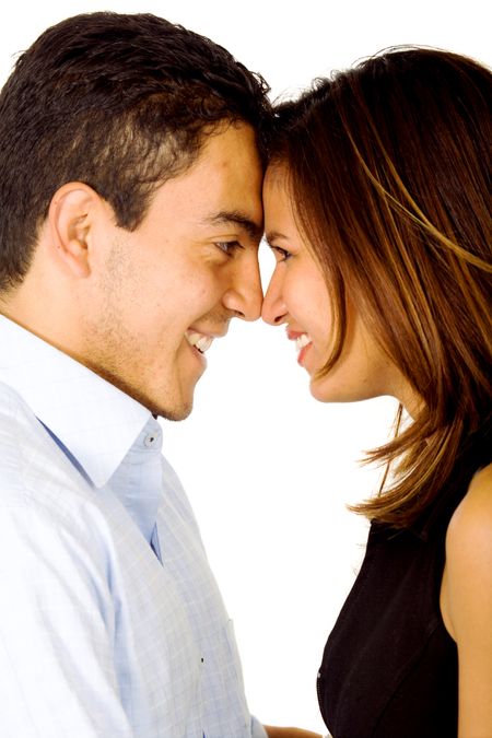 young couple smiling and standing facing each other - isolated over a white background