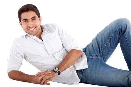 Handsome man lying on the floor smiling - isolated over a white background