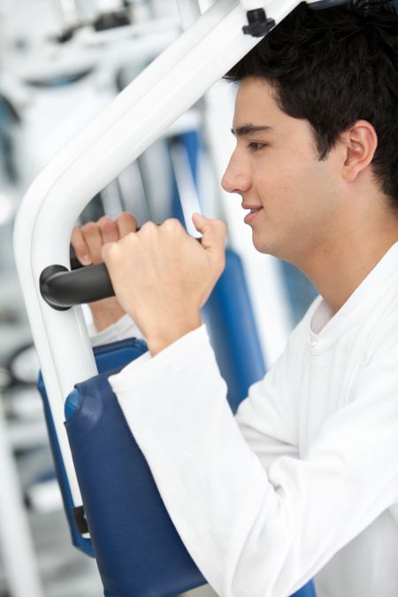 Man at the gym exercising on a machine