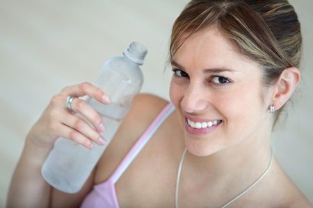 Beautiful woman at the gym with a bottle of water