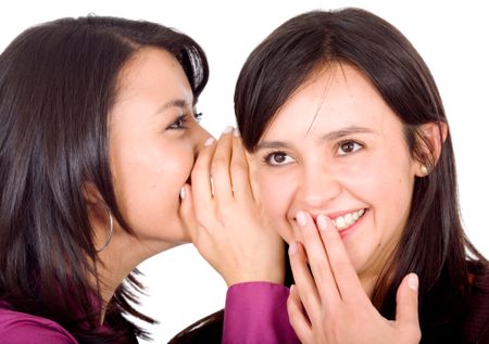 girl telling a secret to another - gossip isolated over a white background