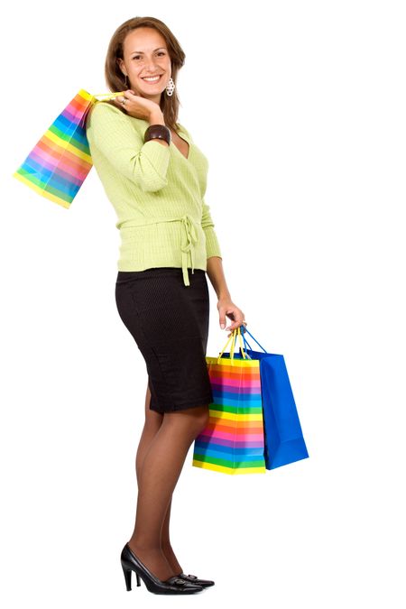 business woman smiling holding shopping bags - isolated over a white background