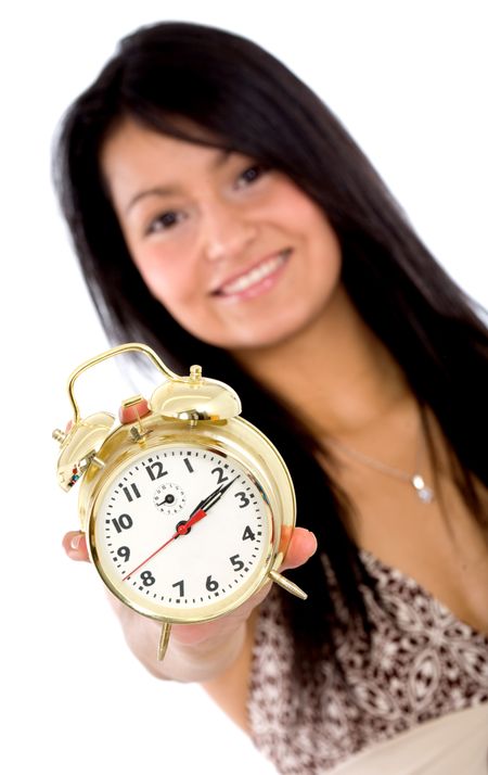alarm clock held by a beautiful girl isolated over a white background
