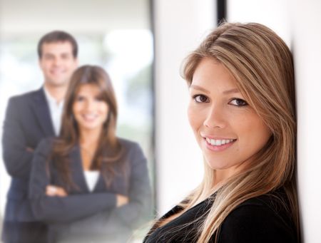 Business woman at the office with a group on the background