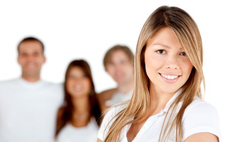 Woman smiling with a group behind - isolated over a white background