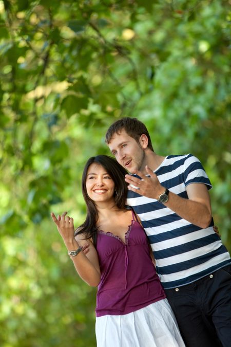 Beautiful young couple smiling and walking outdoors