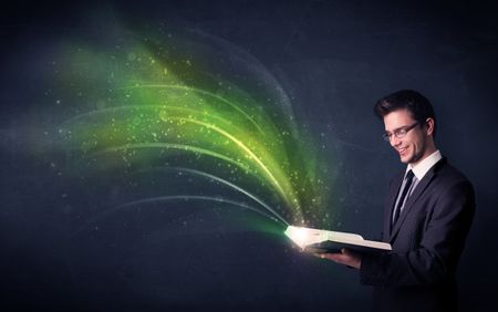 Casual young man holding book with green wave flying out of it