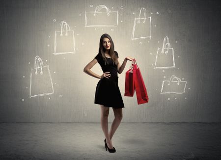 A beautiful young girl in black standing with red shopping bags in front of brown background wall and drawing illustration concept